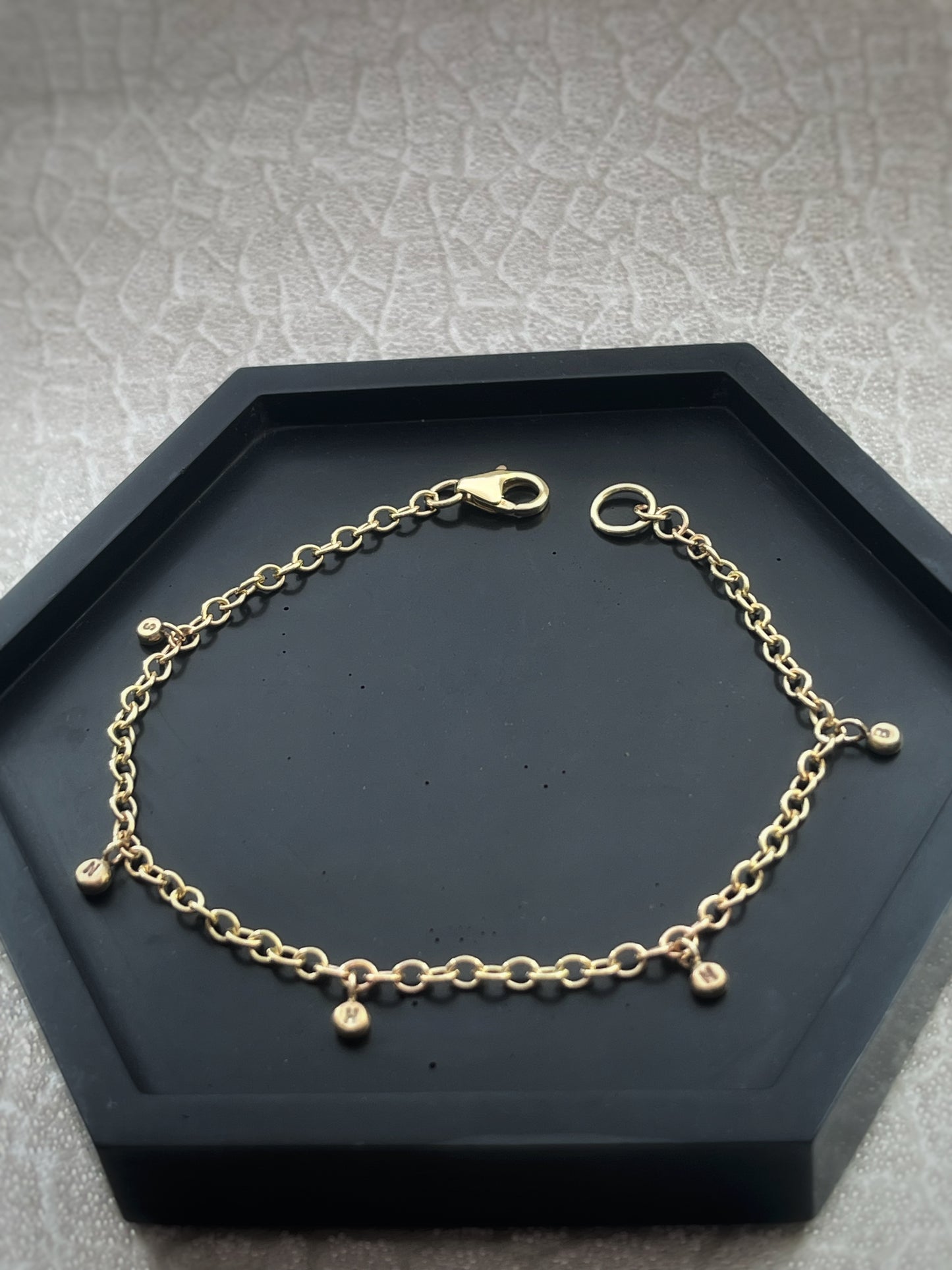 Solid 9ct gold personalised 5 letter pebble charm bracelet, recycled initial handmade chain bracelet