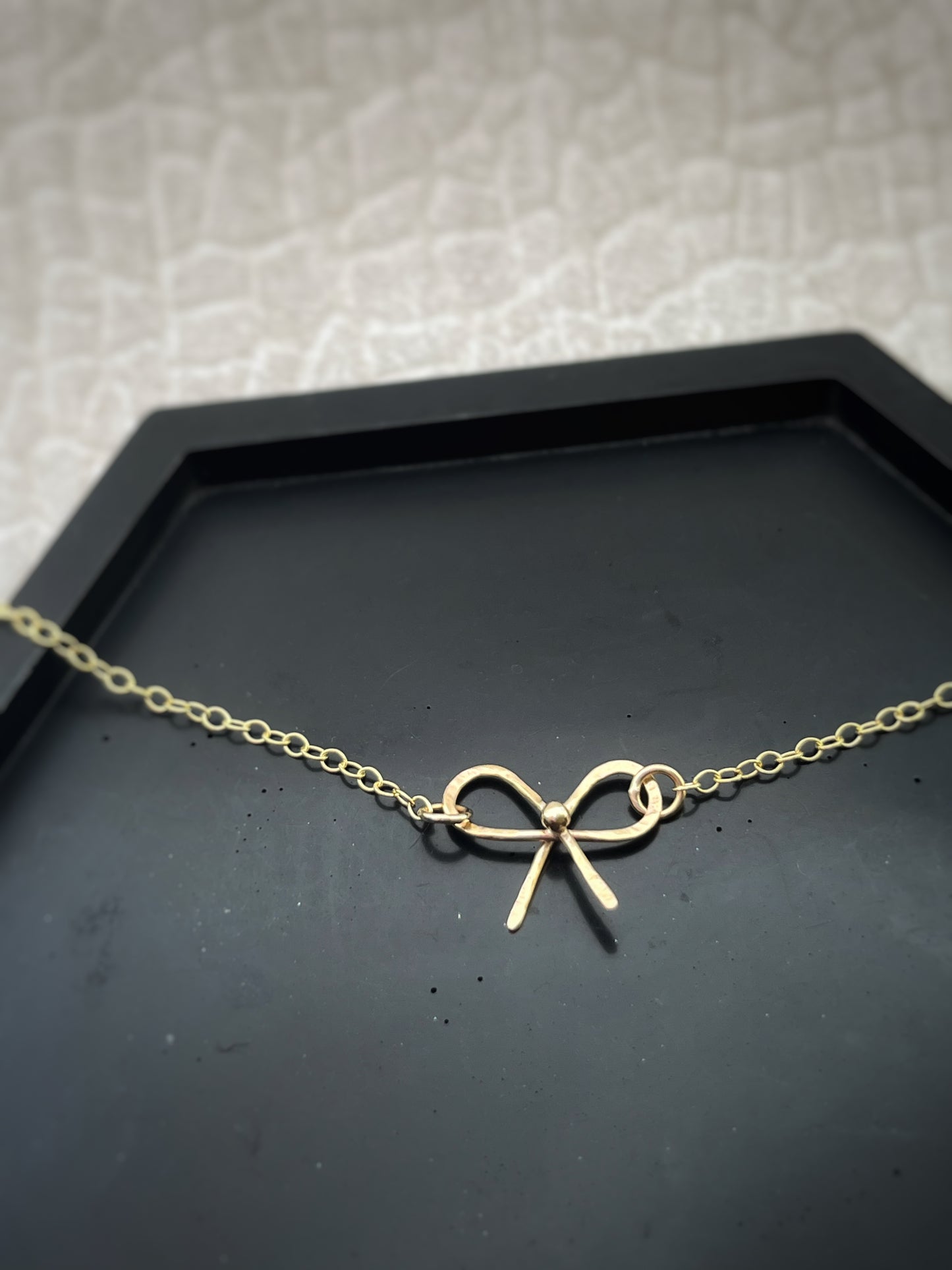 Solid 9ct solid gold bow necklace, a handmade hammered textured ribbon style bow