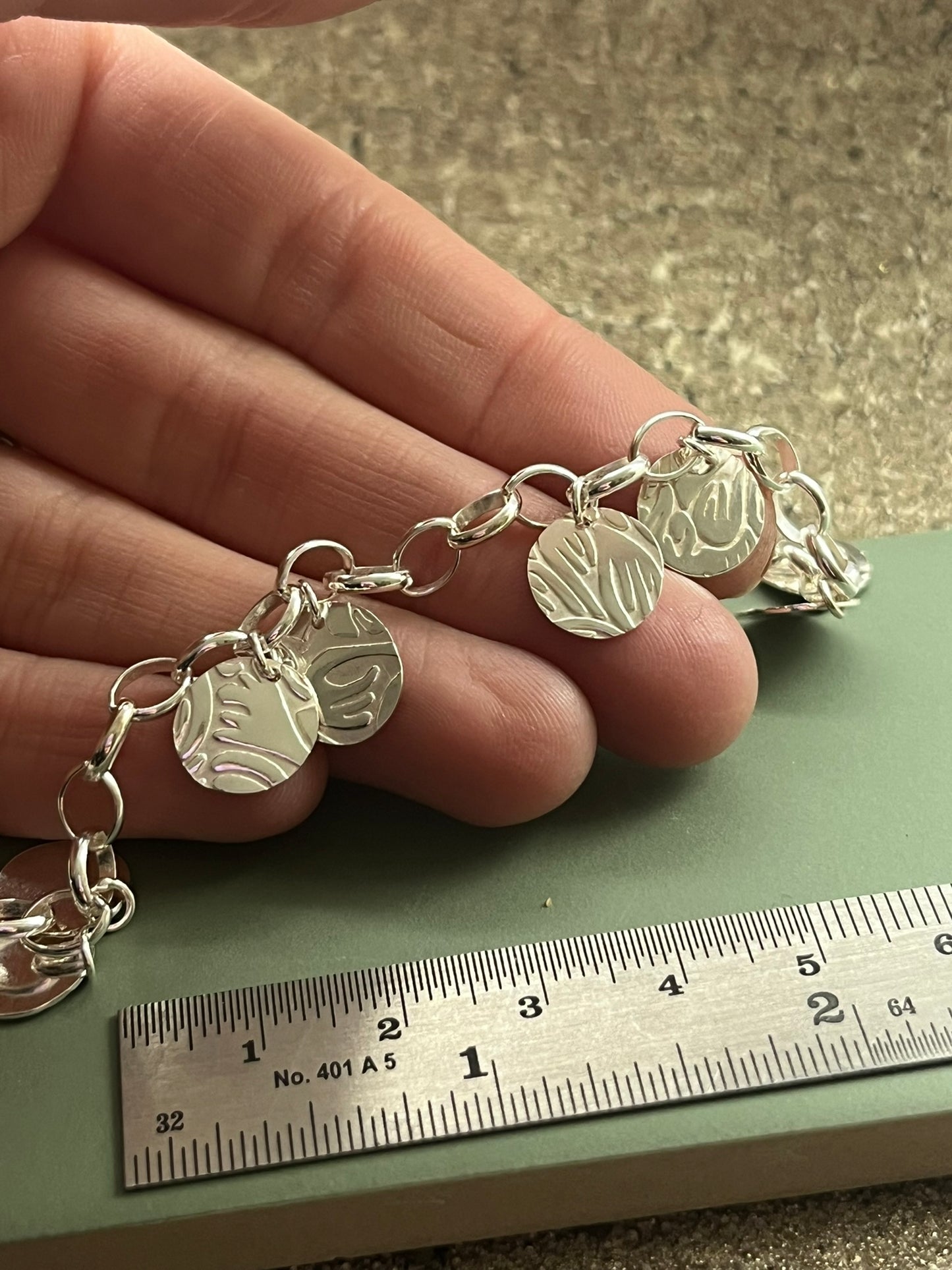 Floral embossed sterling silver charm bracelet