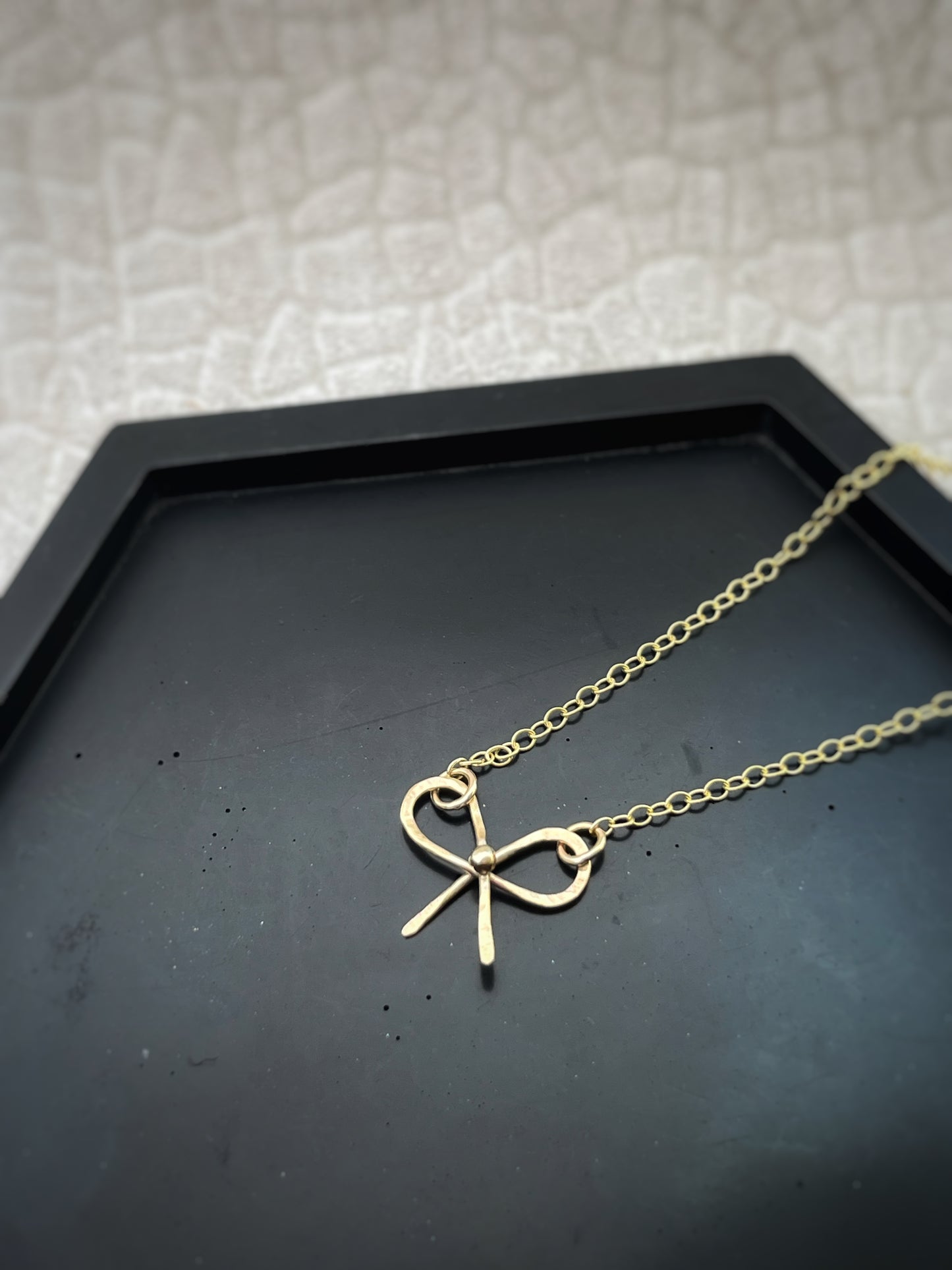 Solid 9ct solid gold bow necklace, a handmade hammered textured ribbon style bow