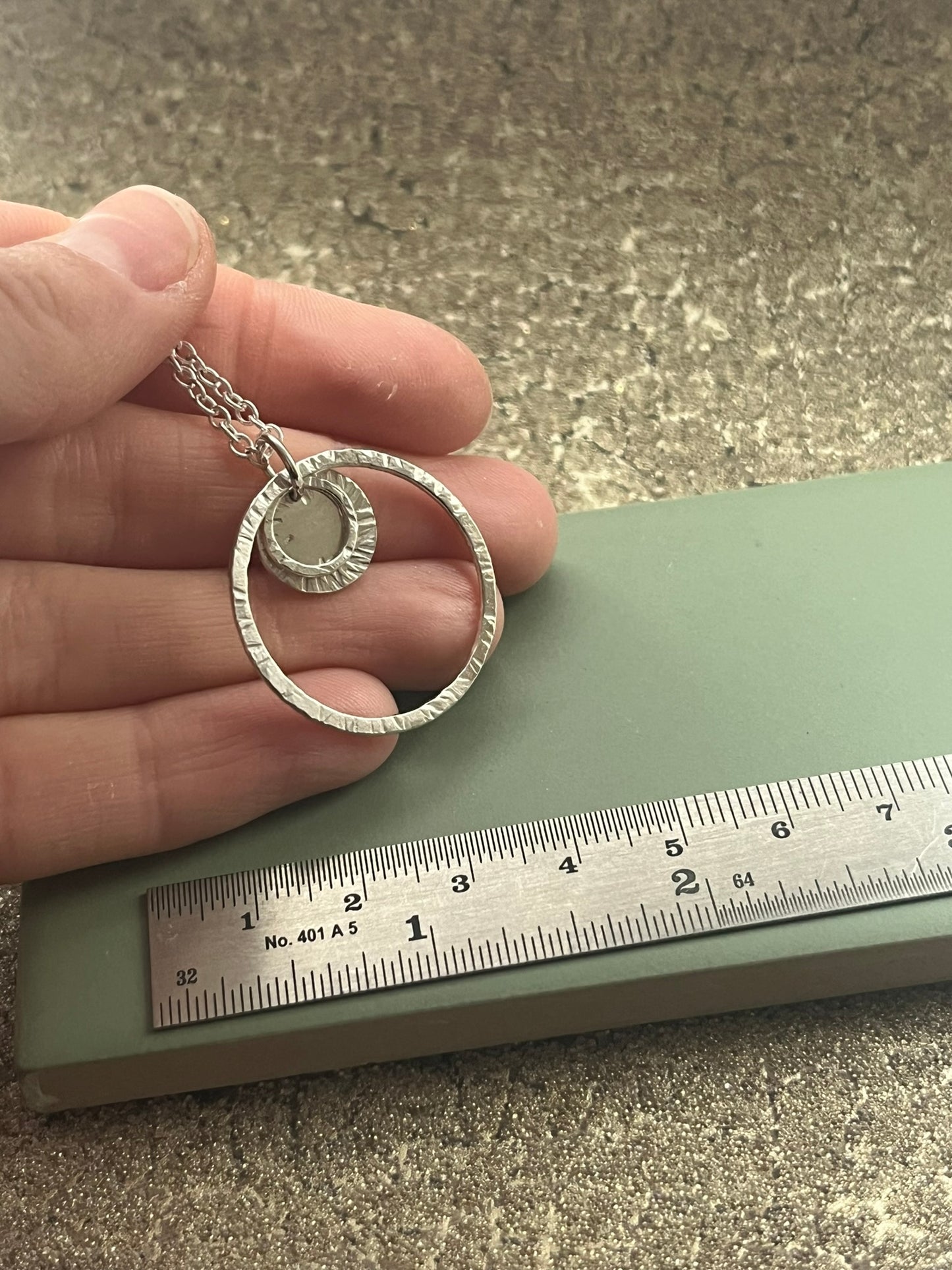 Triple hammered sterling silver hoop pendant