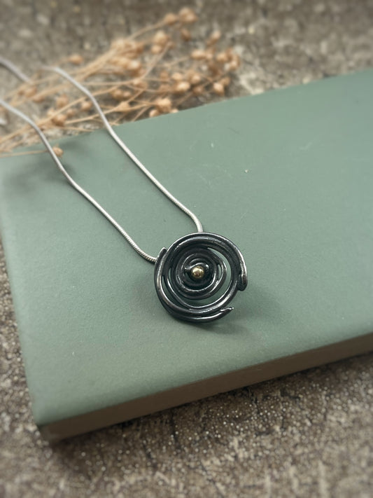 Oxidised blackened silver & 18ct gold swirl small pendant