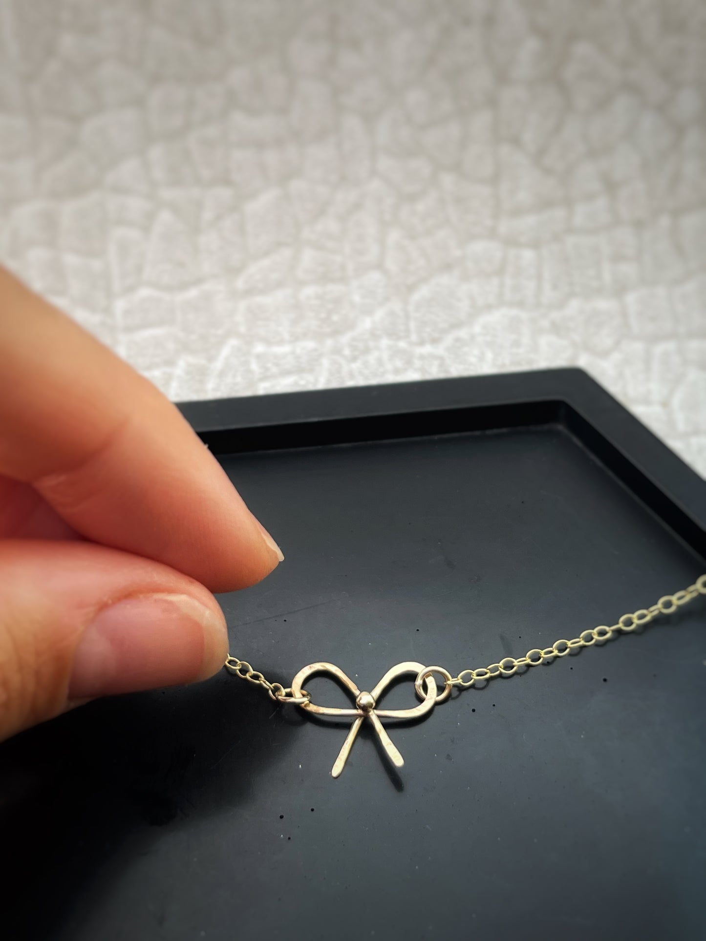 Solid 9ct solid gold bow necklace, a handmade hammered textured ribbon style bow