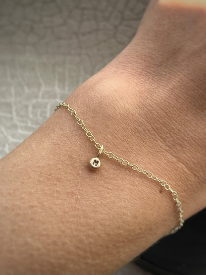 Solid 9ct gold tiny letter pebble bracelet, recycled personalised initial stacking handmade